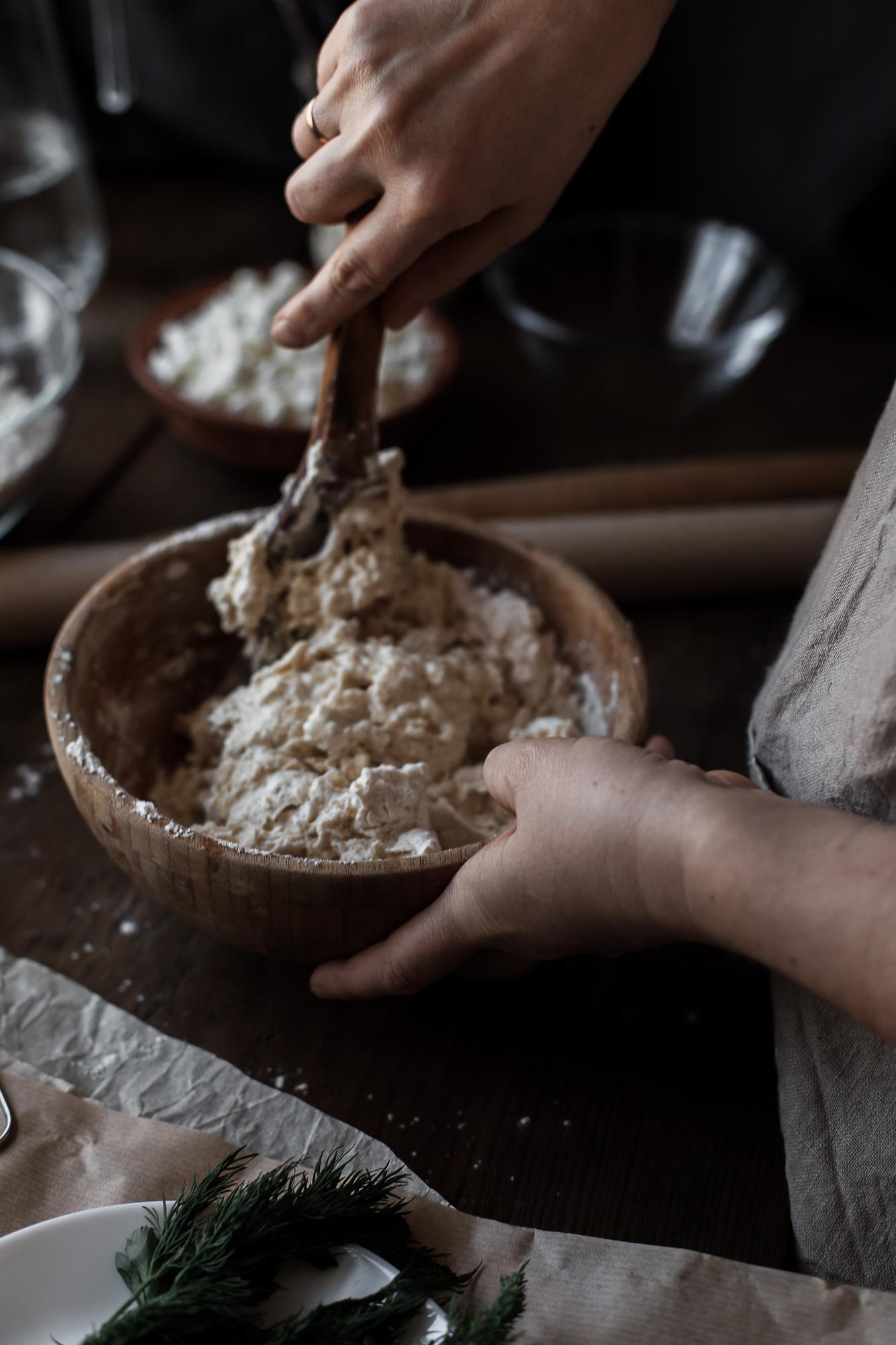 hands kneading dough in natural light