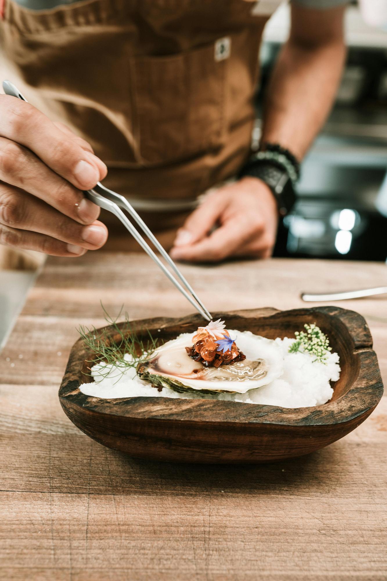 chef plating in a rustic kitchen